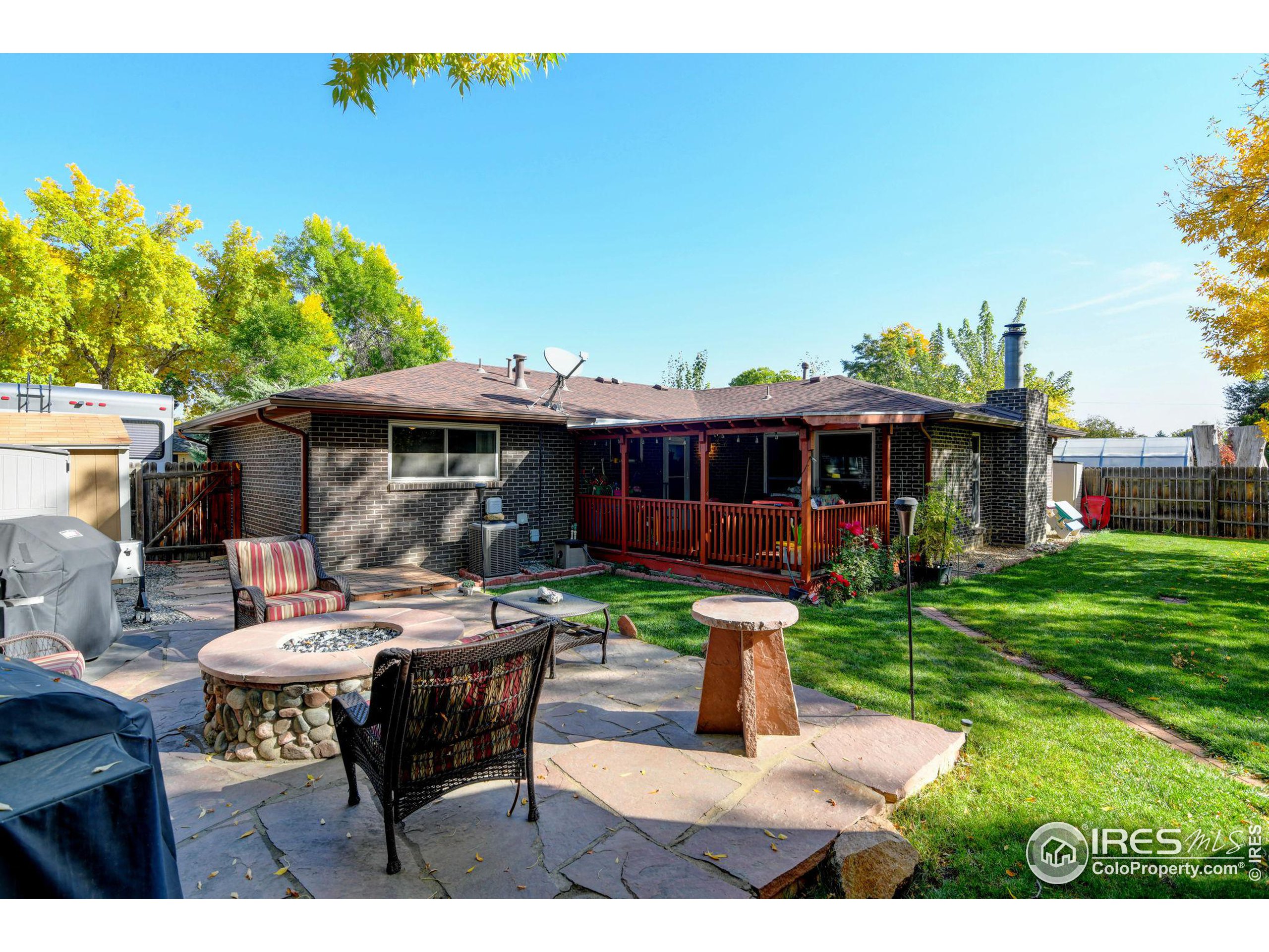 a view of house with backyard sitting area and garden