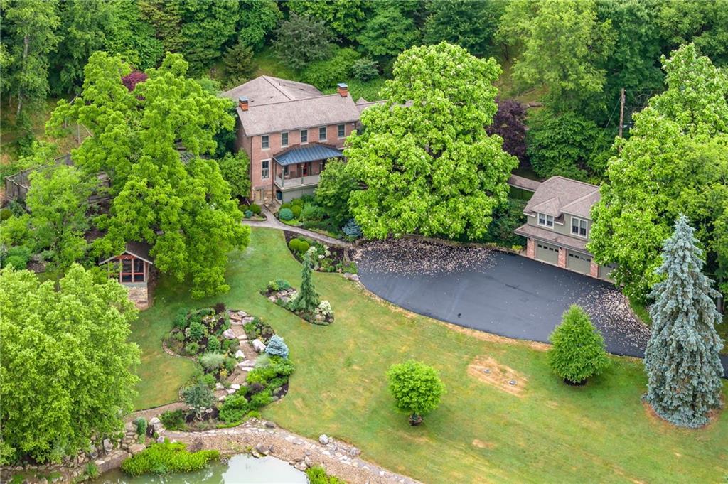 an aerial view of a house with a yard basket ball court and outdoor seating