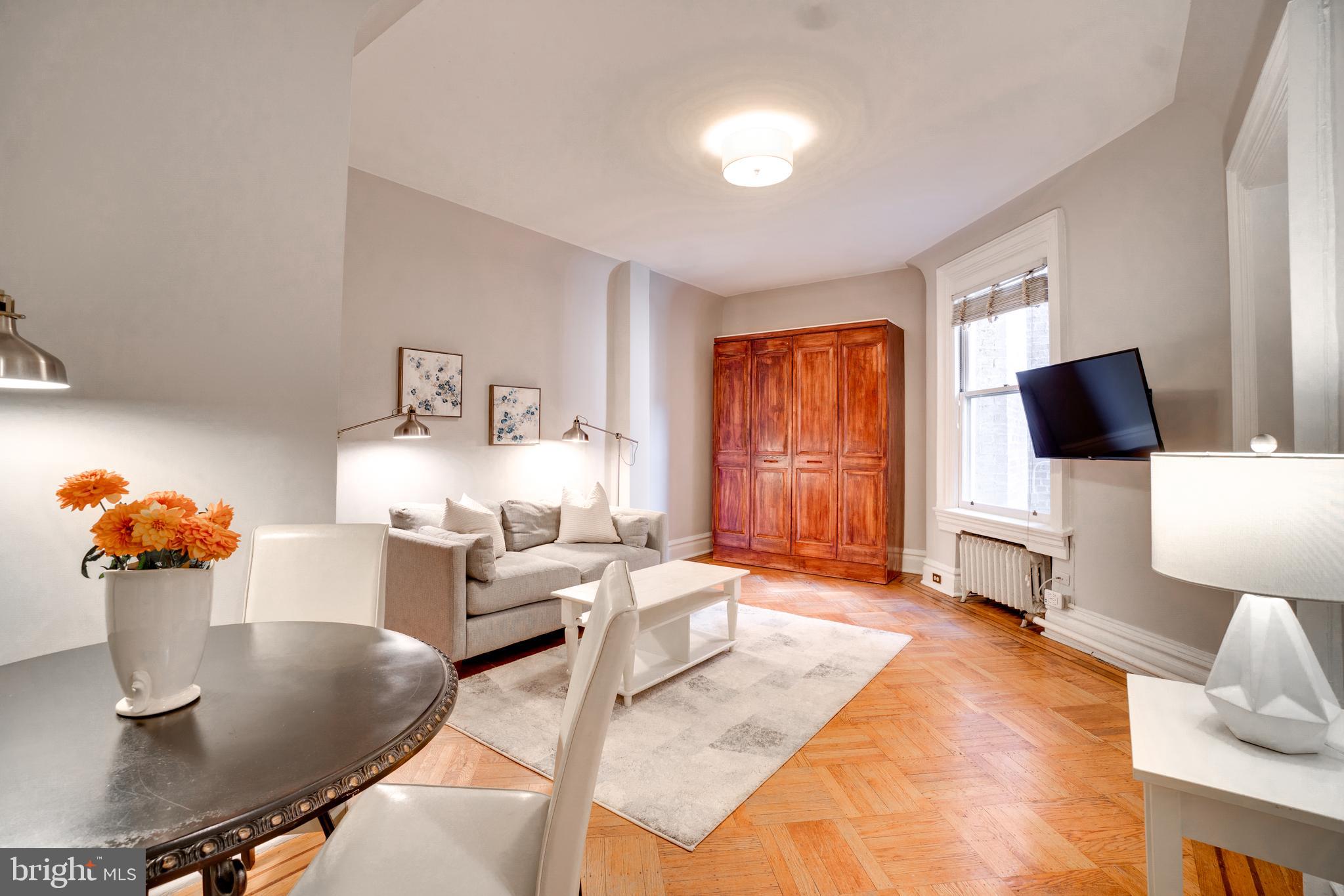 a living room with furniture and flat screen tv