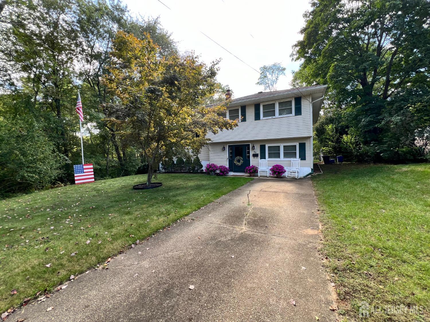 a view of a house with a yard and tree s