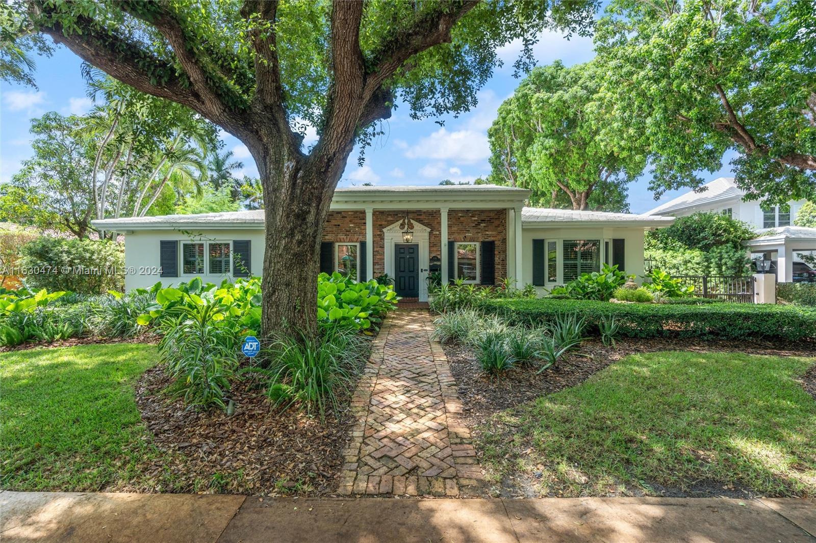 a front view of a house with a garden