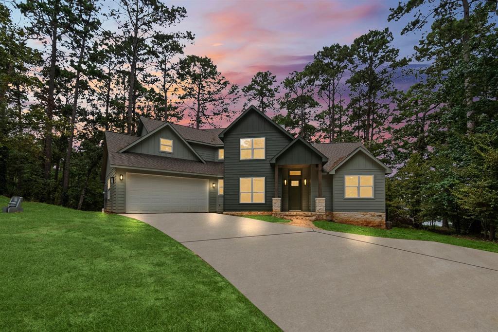 a front view of a house with a garden and yard