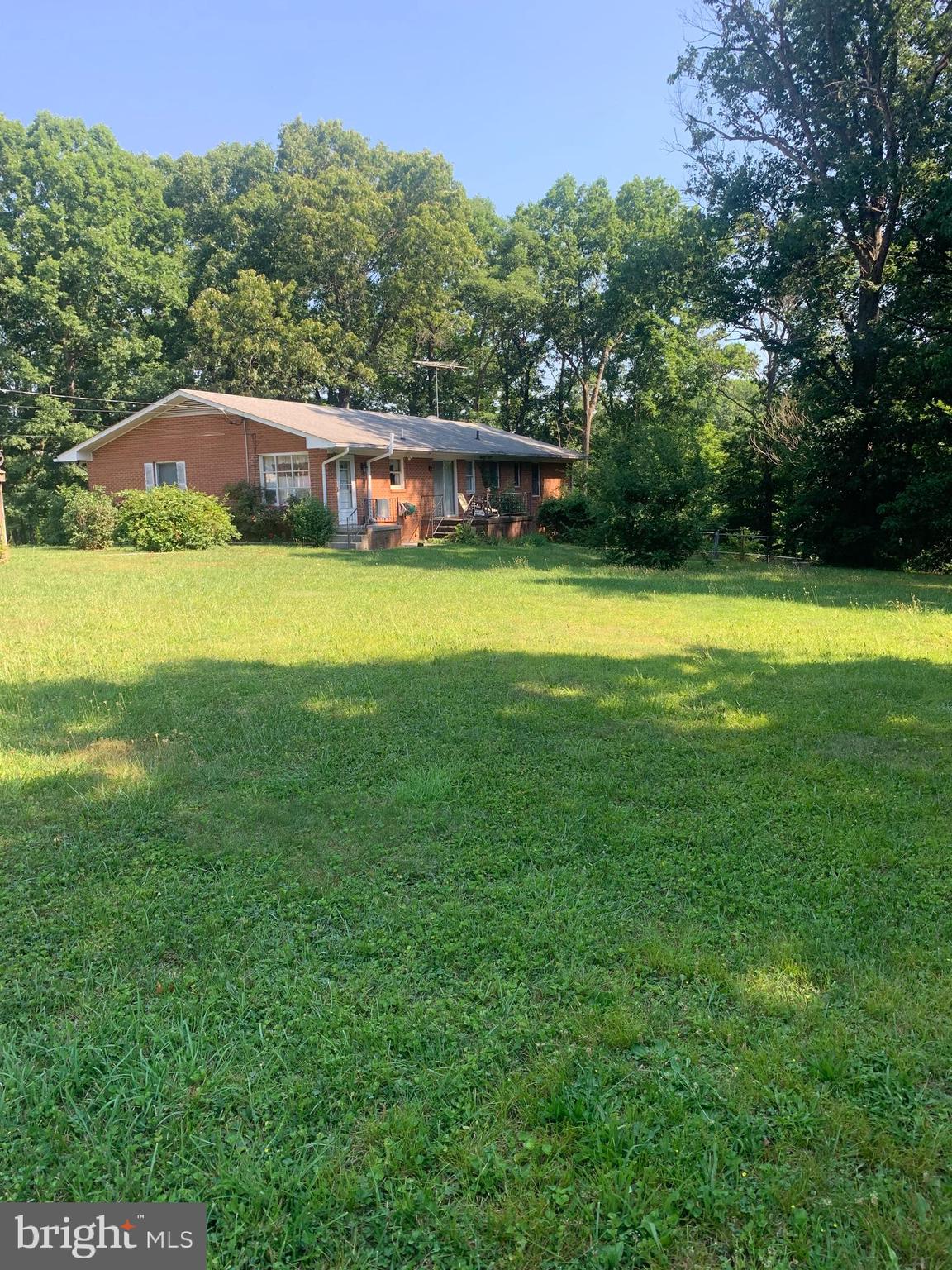 a view of a house with a yard and a large pool