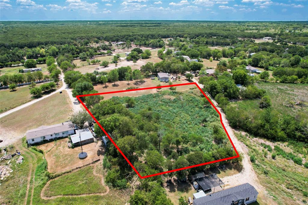 an aerial view of a house and outdoor space