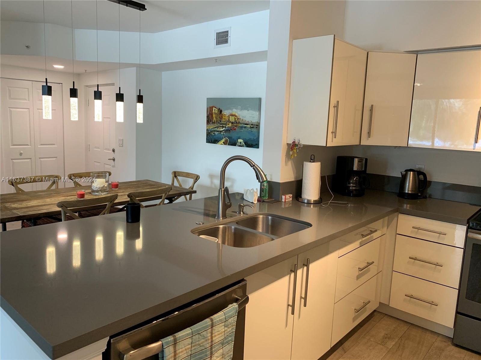 a kitchen with a sink appliances and cabinets