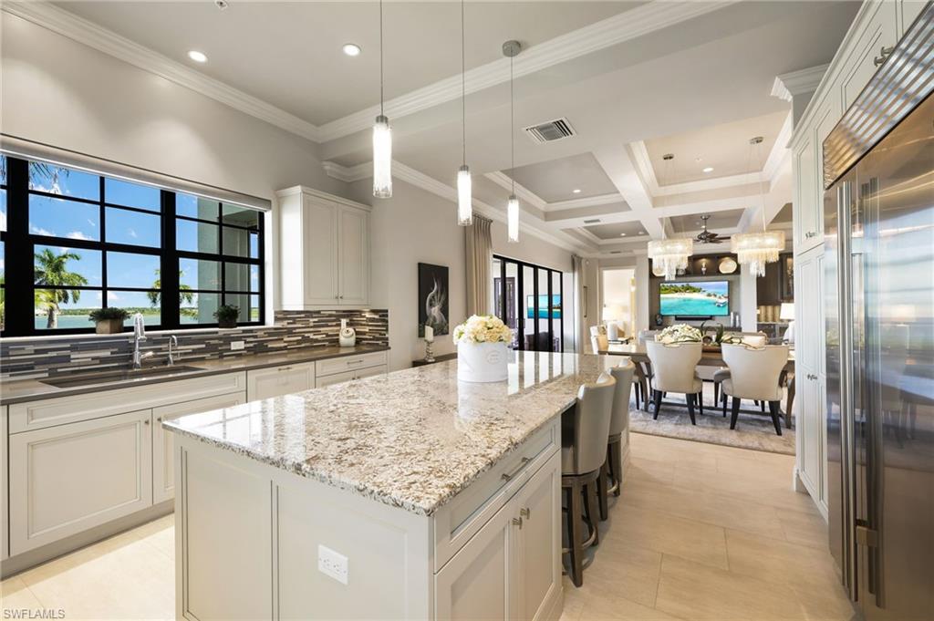 a kitchen with stainless steel appliances granite countertop a sink and a refrigerator