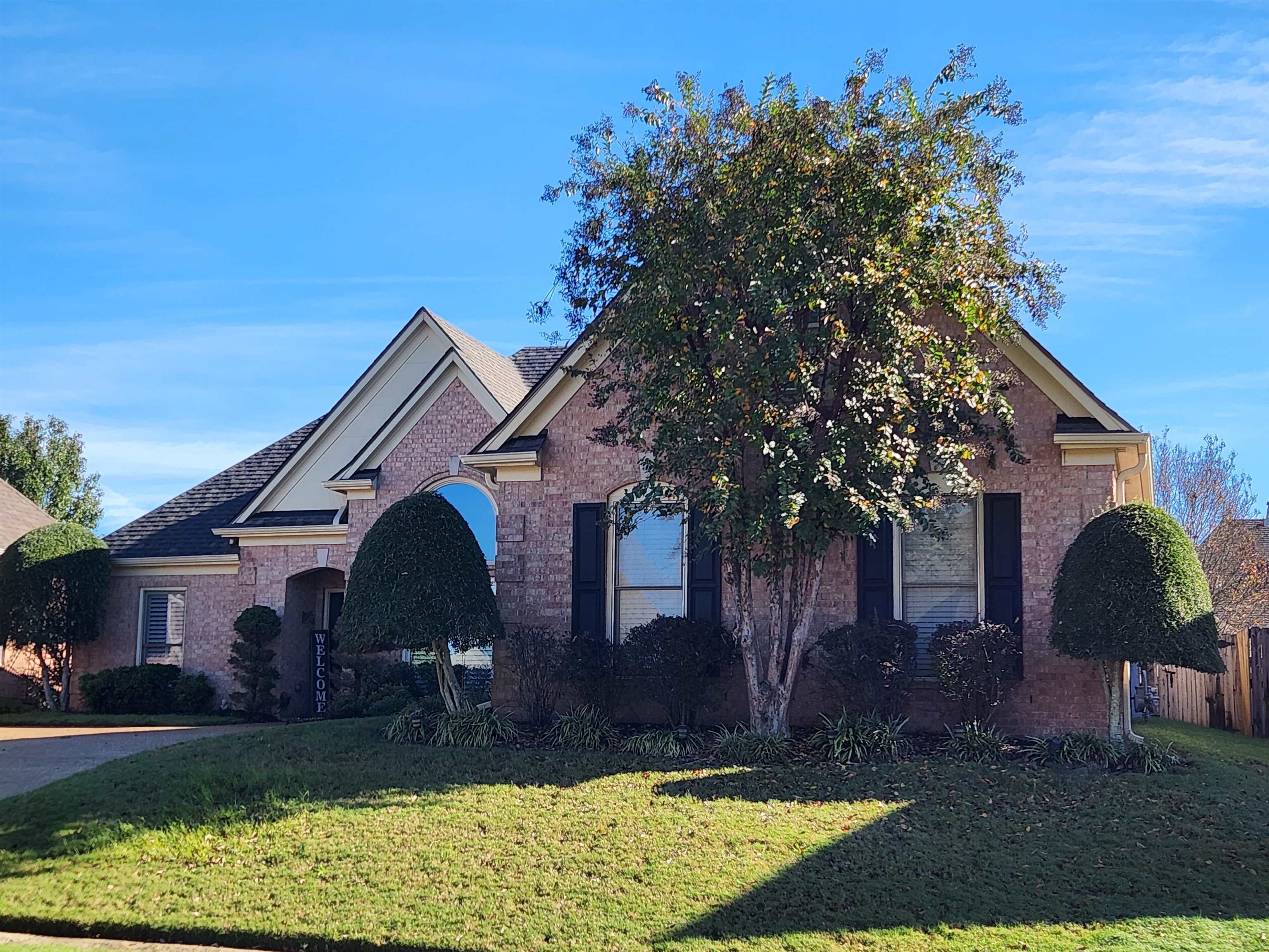 a front view of a house with garden