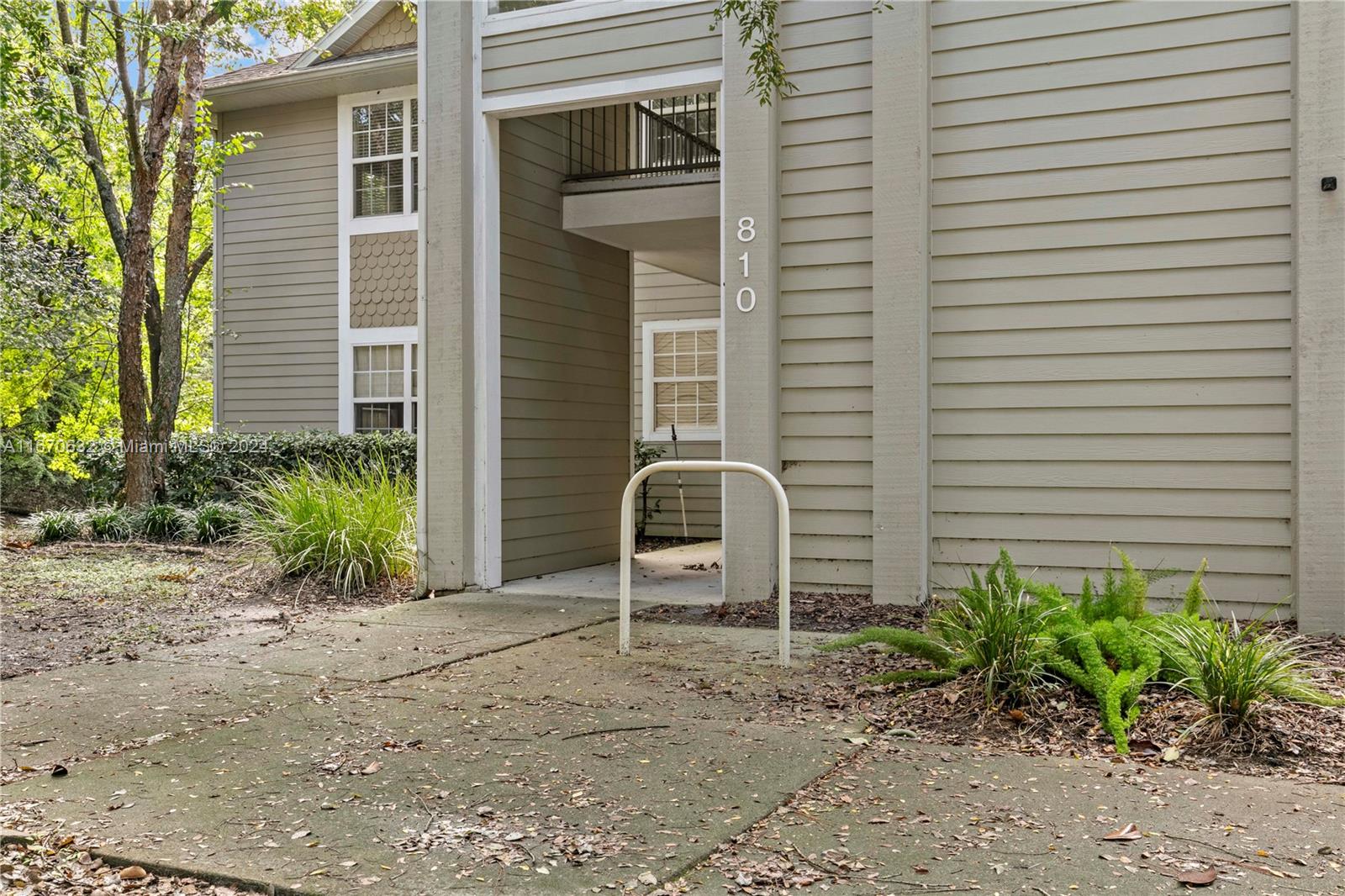 a couple of potted plants in front of door