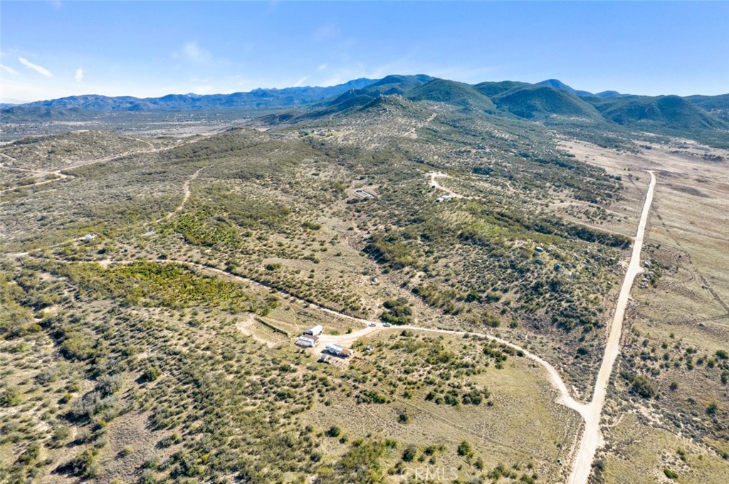 a view of a large mountain with mountains in the background