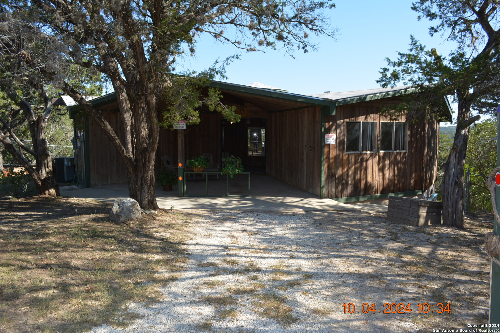 a view of a house with a large tree