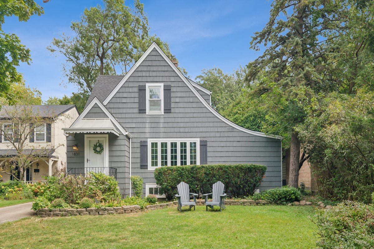 a front view of a house with yard and green space