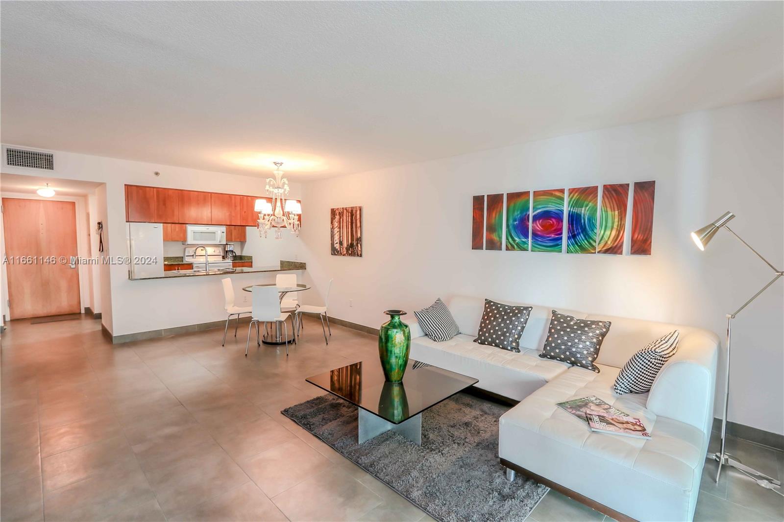 a living room with furniture and kitchen view