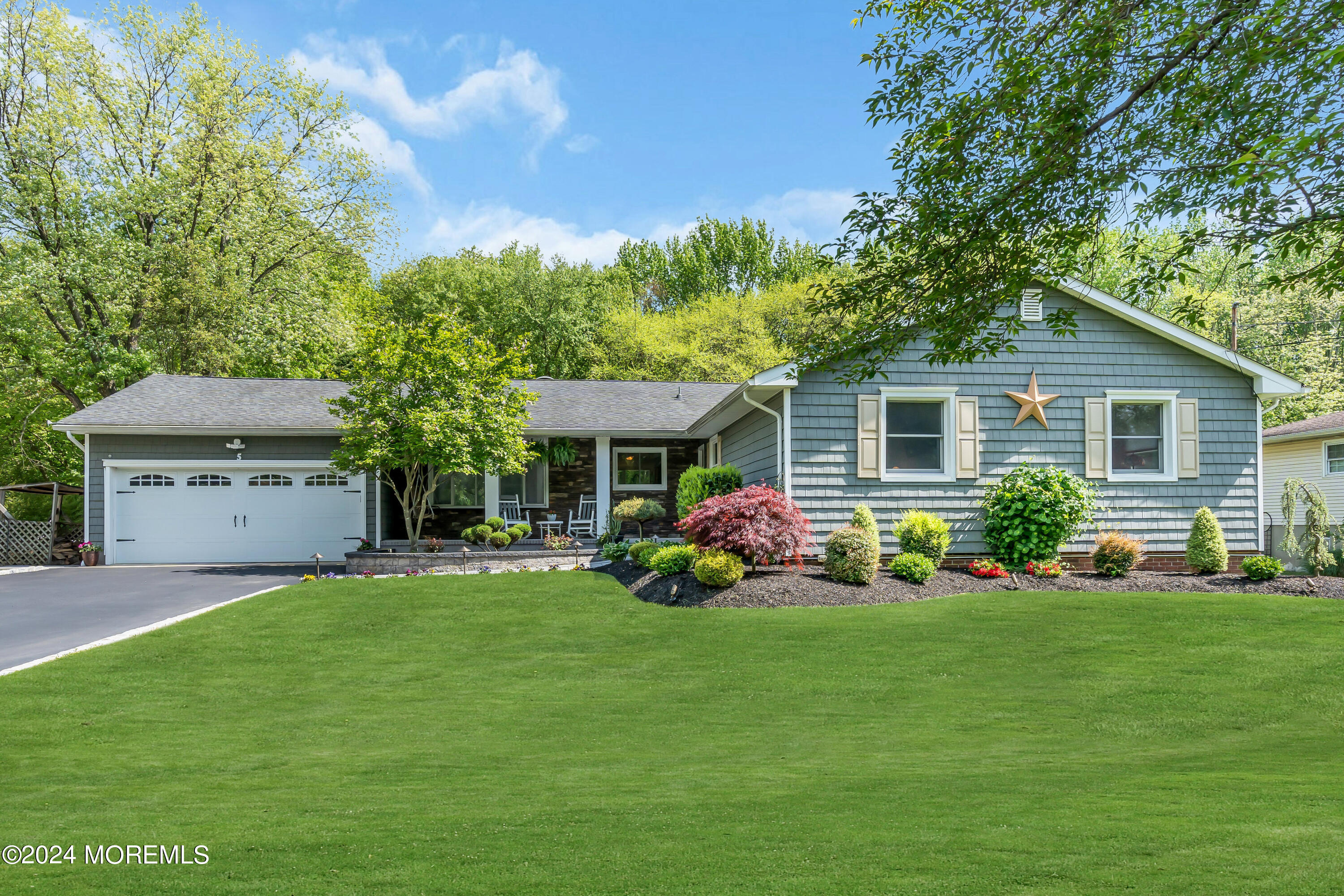 a front view of house with yard and green space