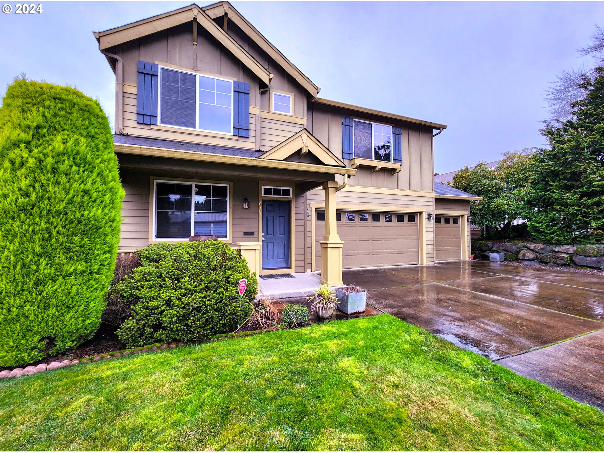 a front view of a house with garden