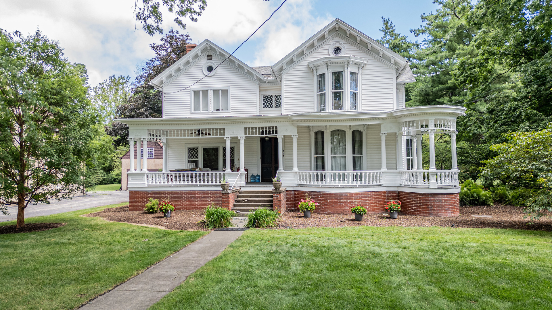 a front view of house with yard and green space