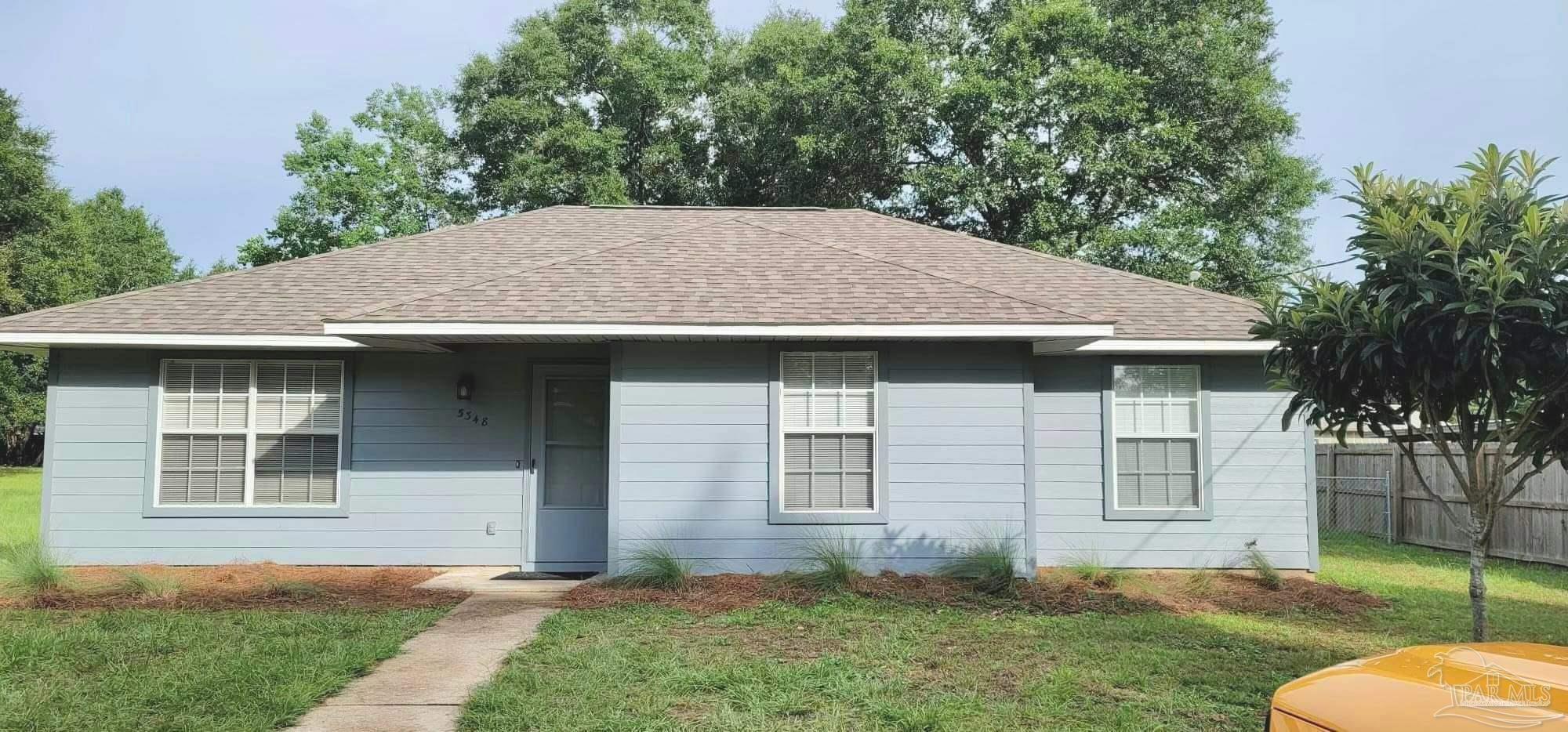 a aerial view of a house with yard and tree in it