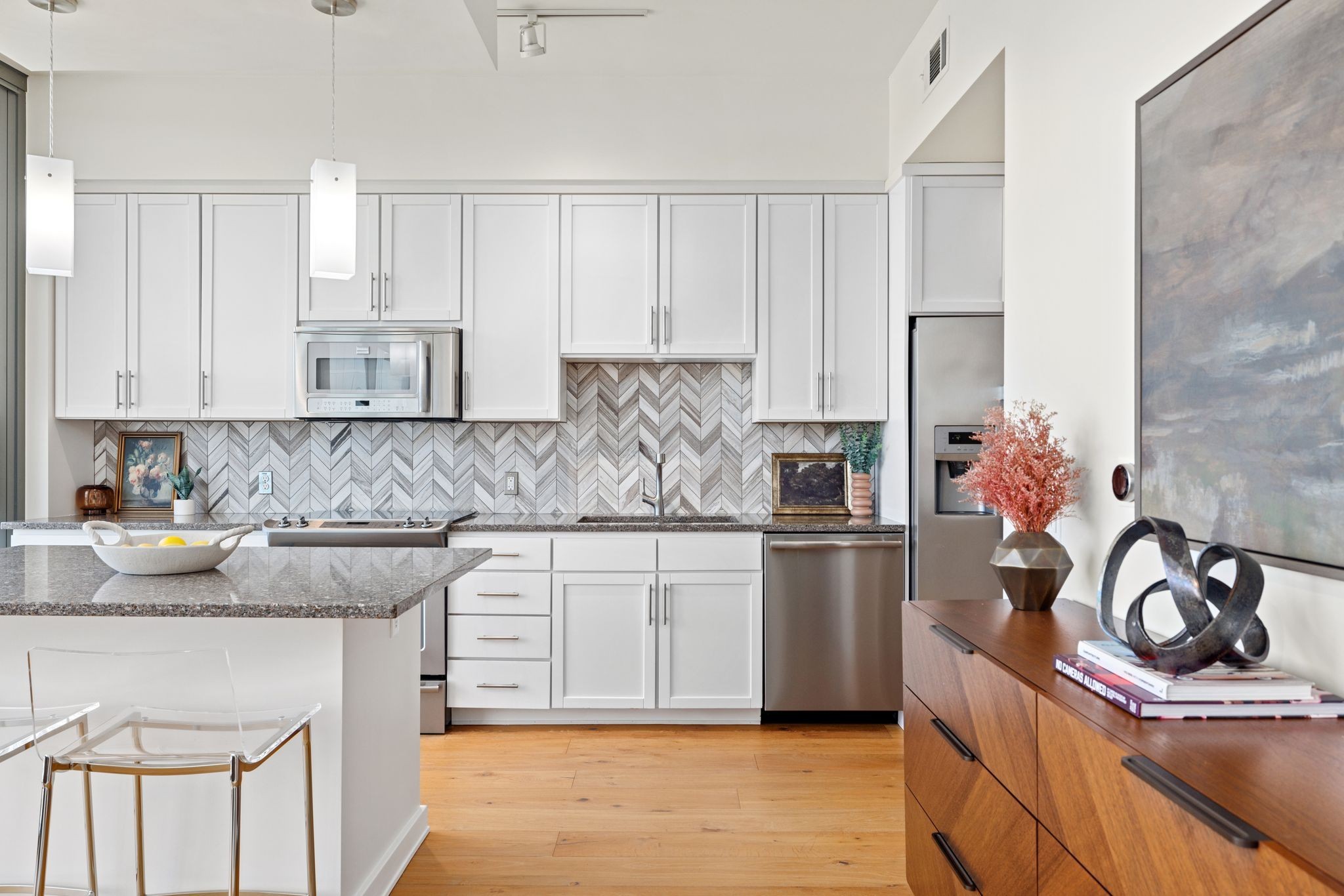 a kitchen with a sink appliances and cabinets