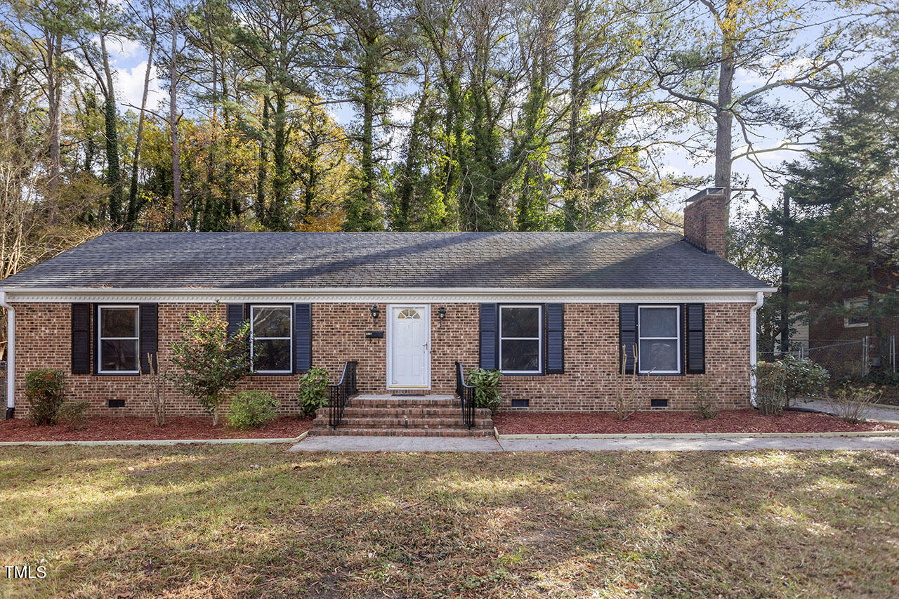 a front view of house with yard and trees