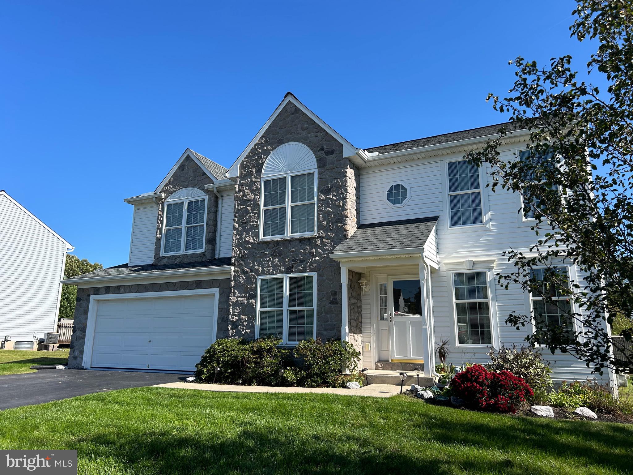 a front view of a house with a yard and porch