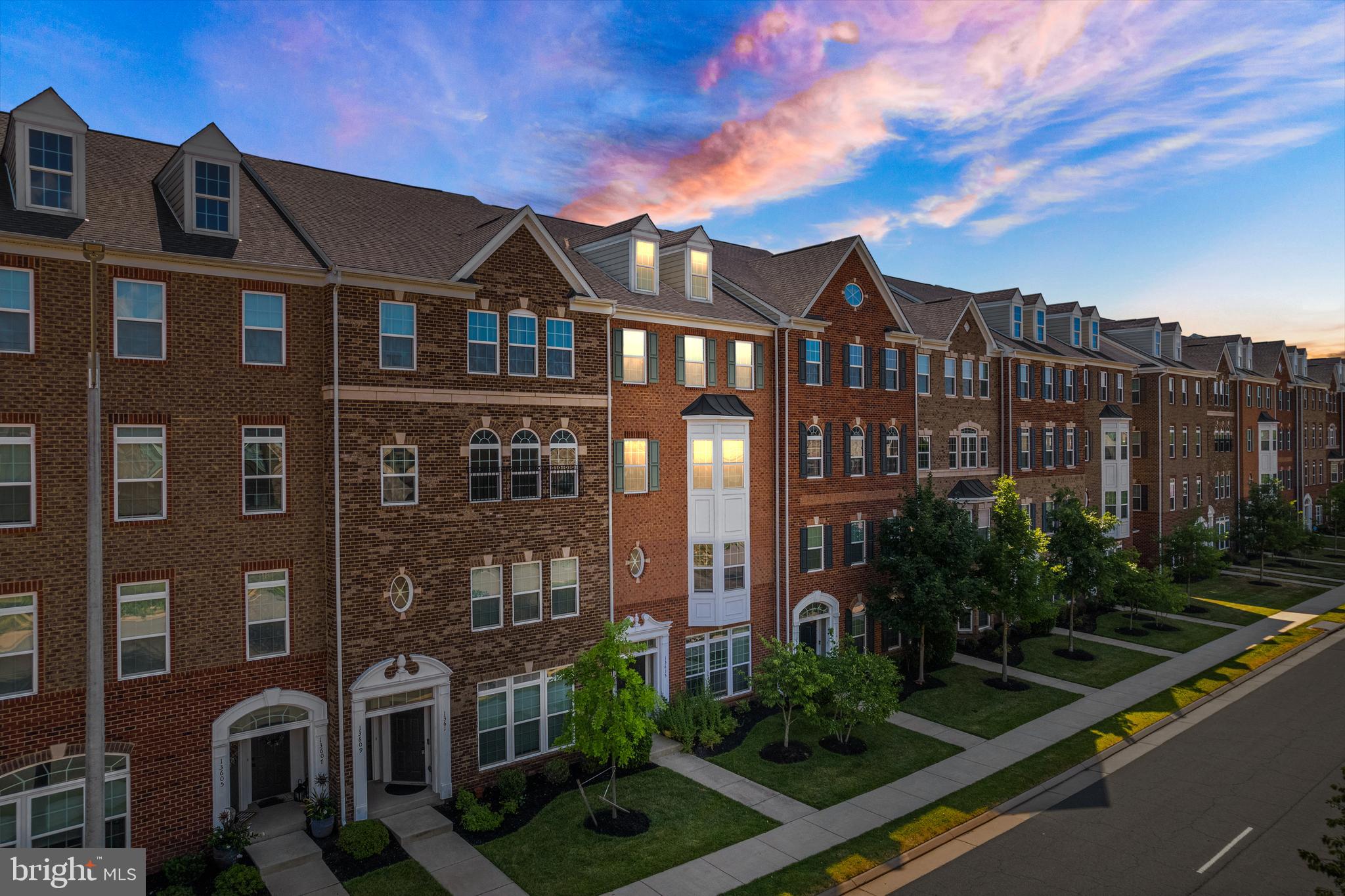 a front view of a residential apartment building with a yard