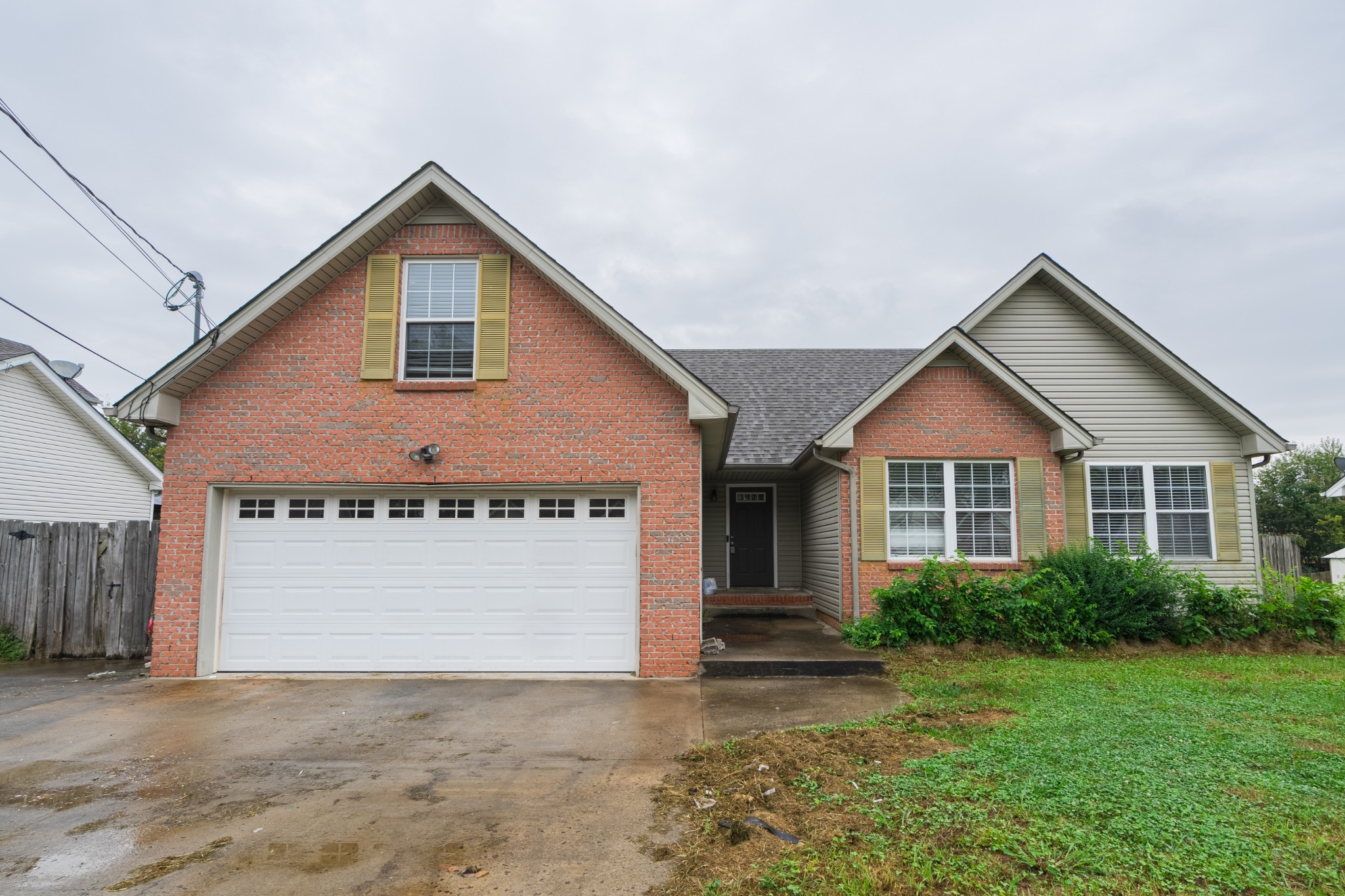 a front view of a house with a garage and yard