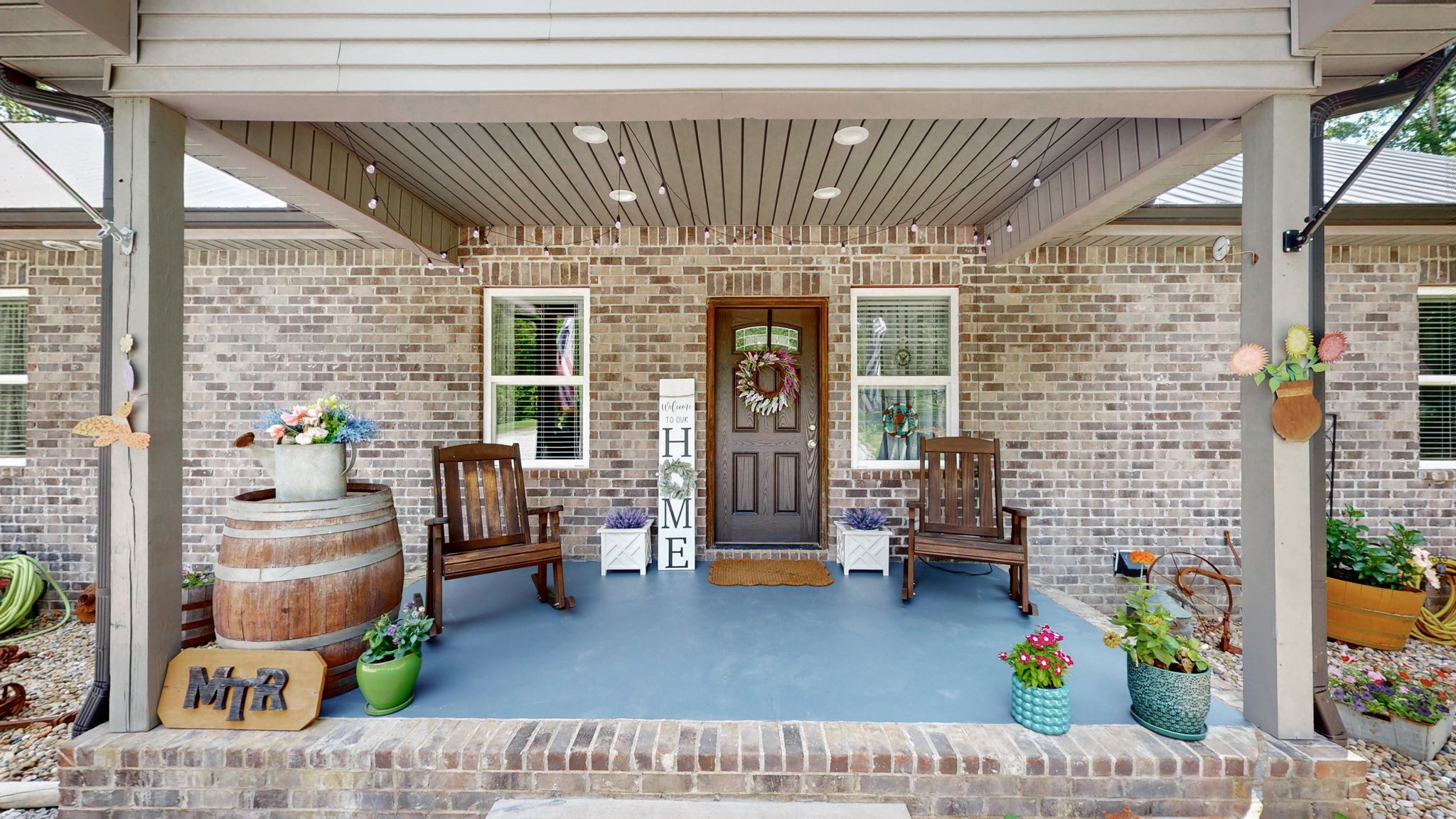 a building outdoor space with patio furniture and potted plants