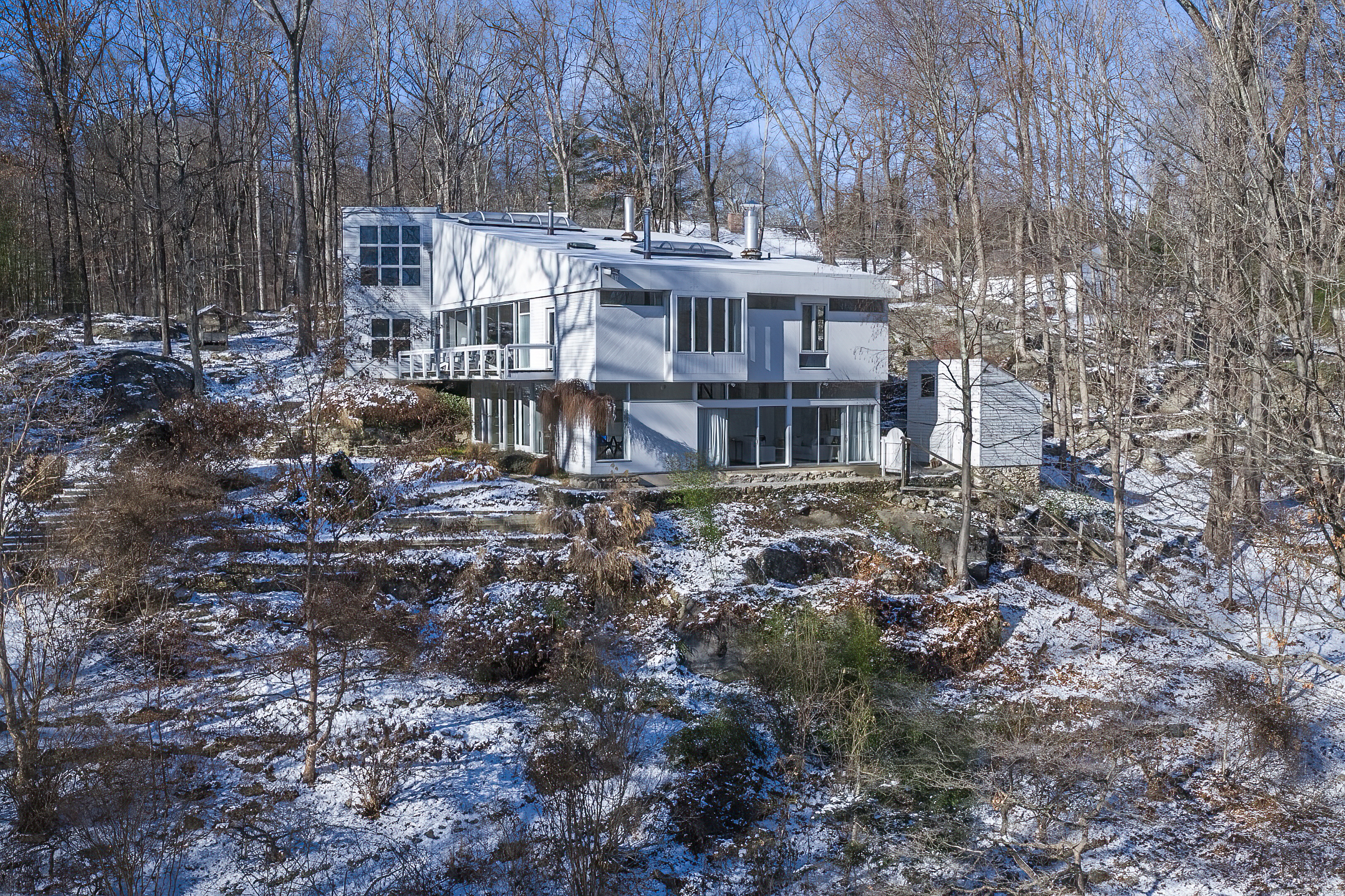 Stunning mid-century modern home viewed from the pond and barn.