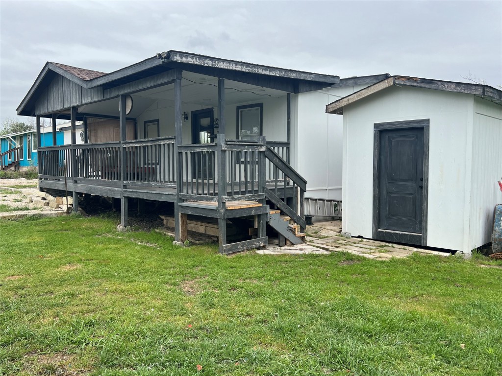 a view of a house with a yard and deck