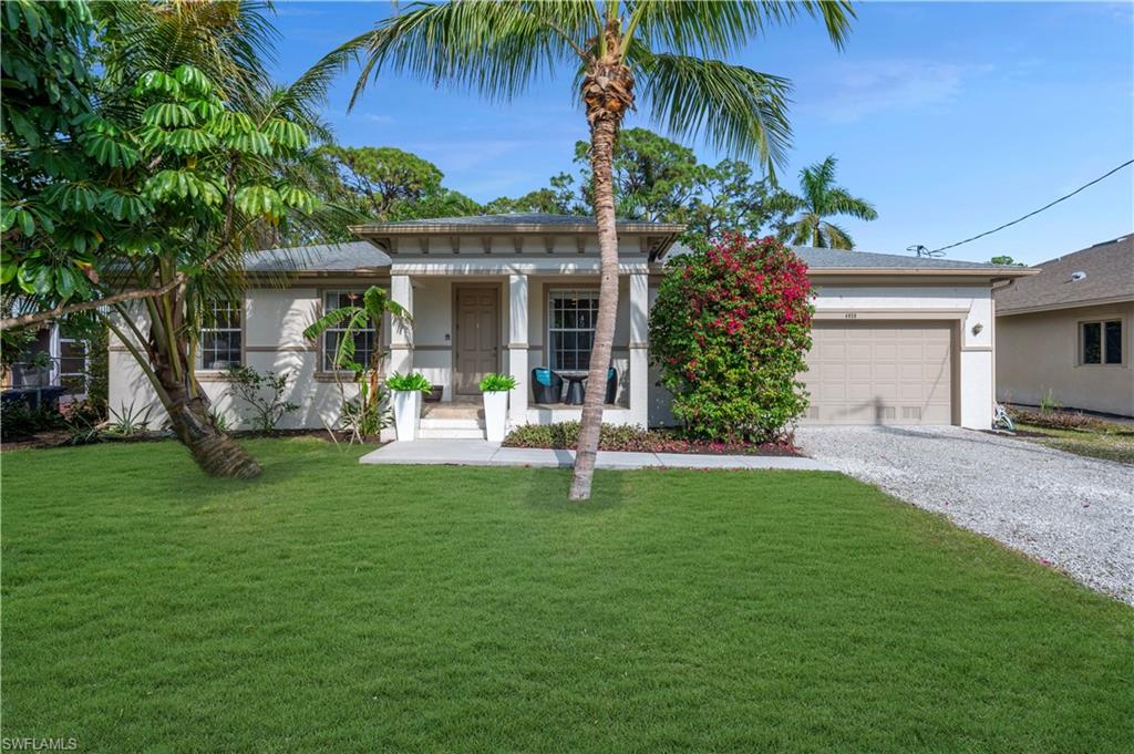 a front view of house with yard and outdoor seating