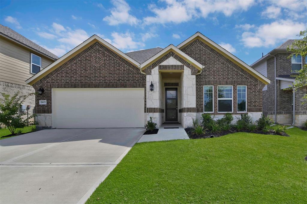 a front view of a house with a yard and garage