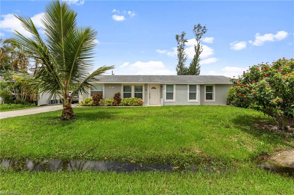 Ranch-style home featuring a front yard