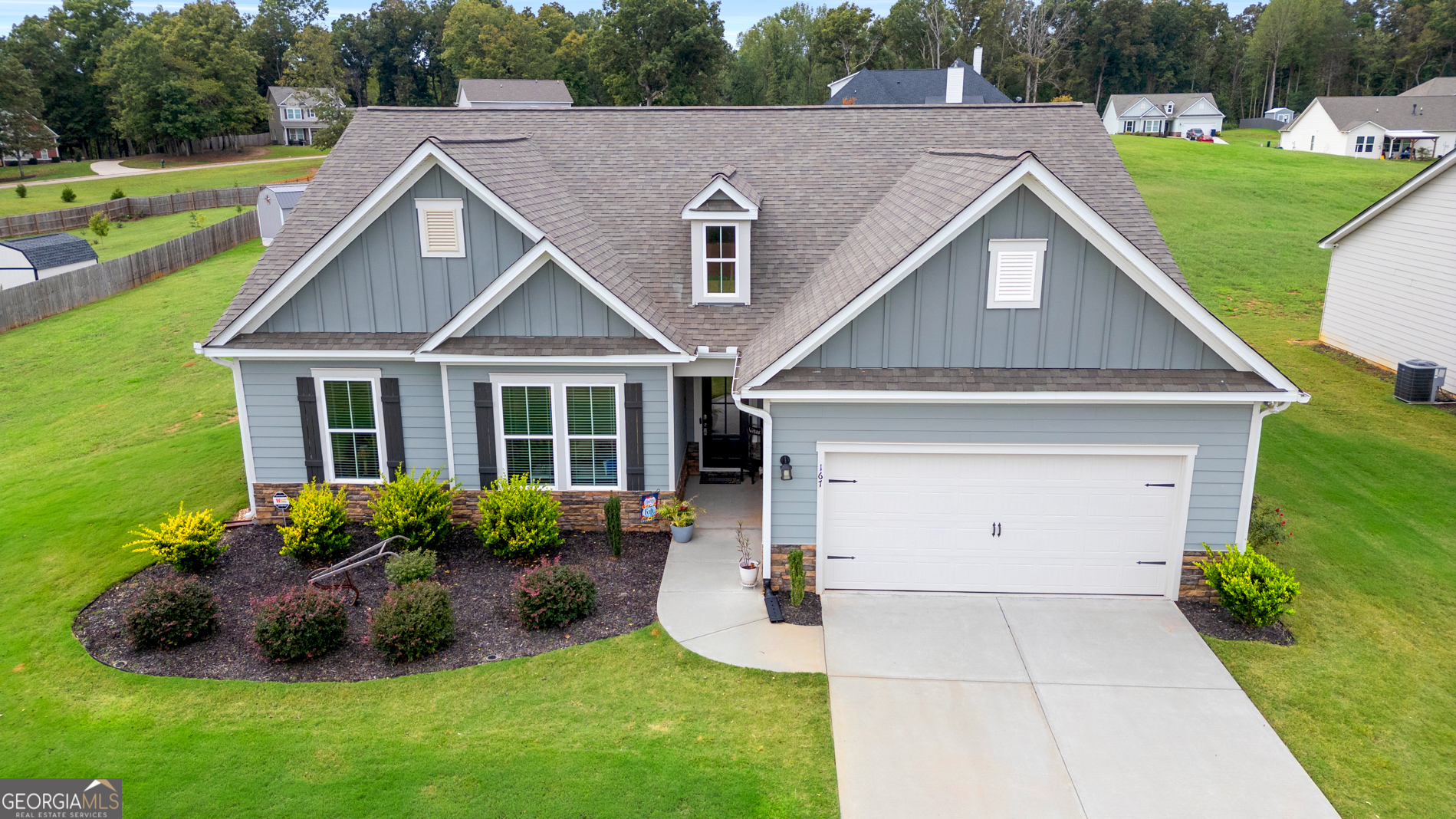 a front view of a house with garden