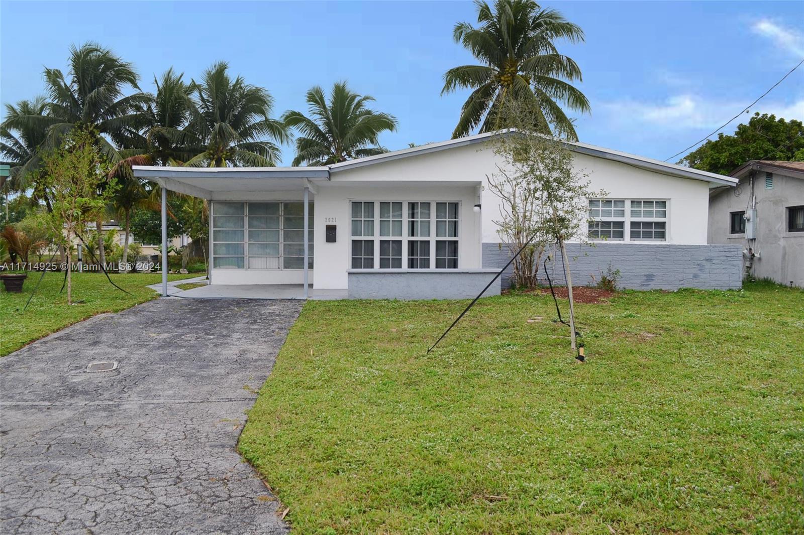 a house with palm tree in front of it