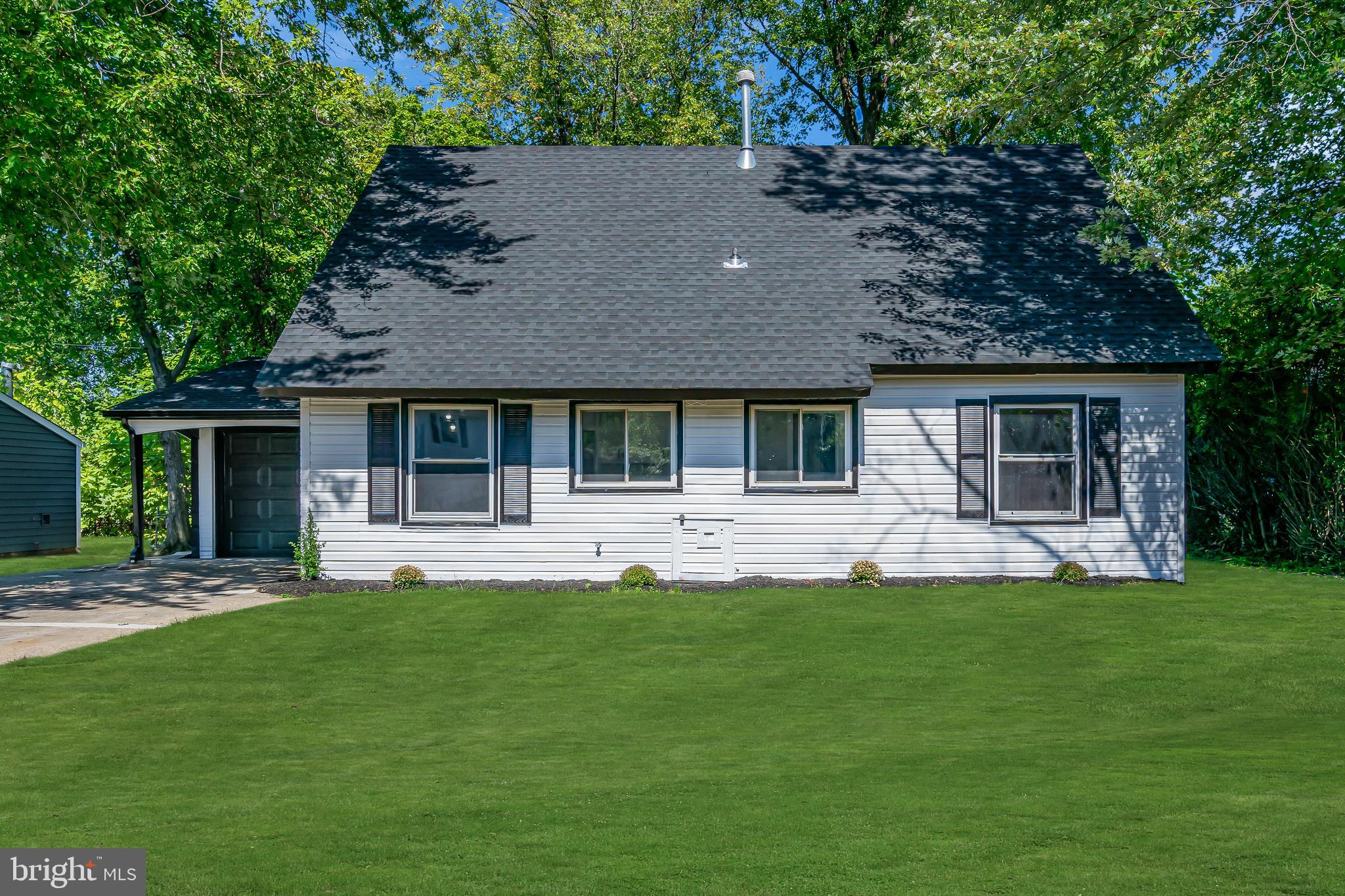 a front view of a house with a garden and porch