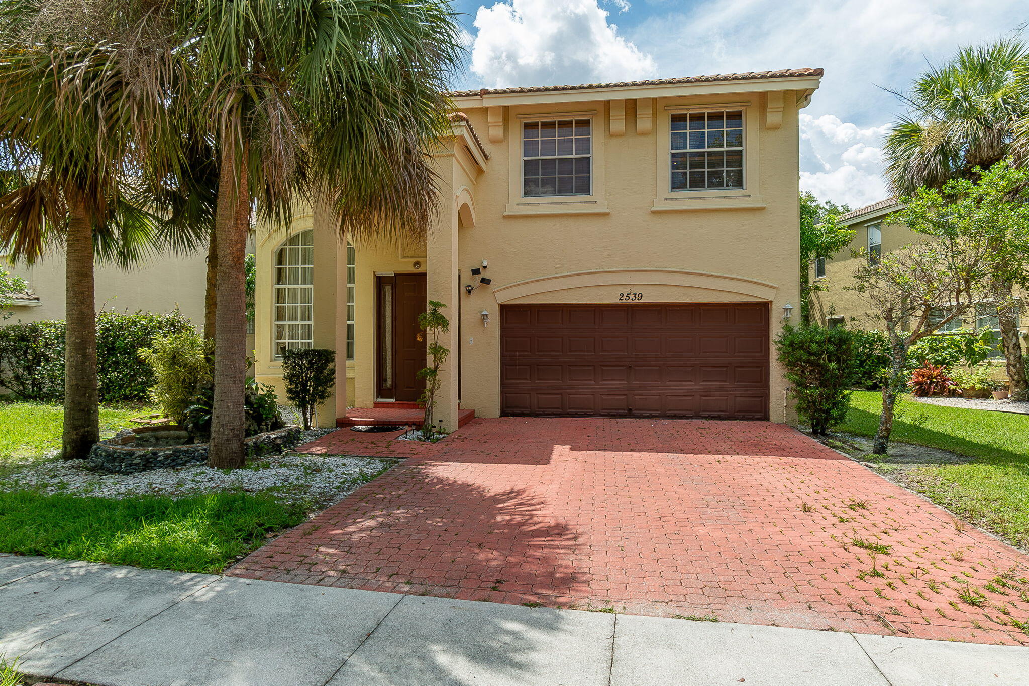 a front view of a house with a yard and garage