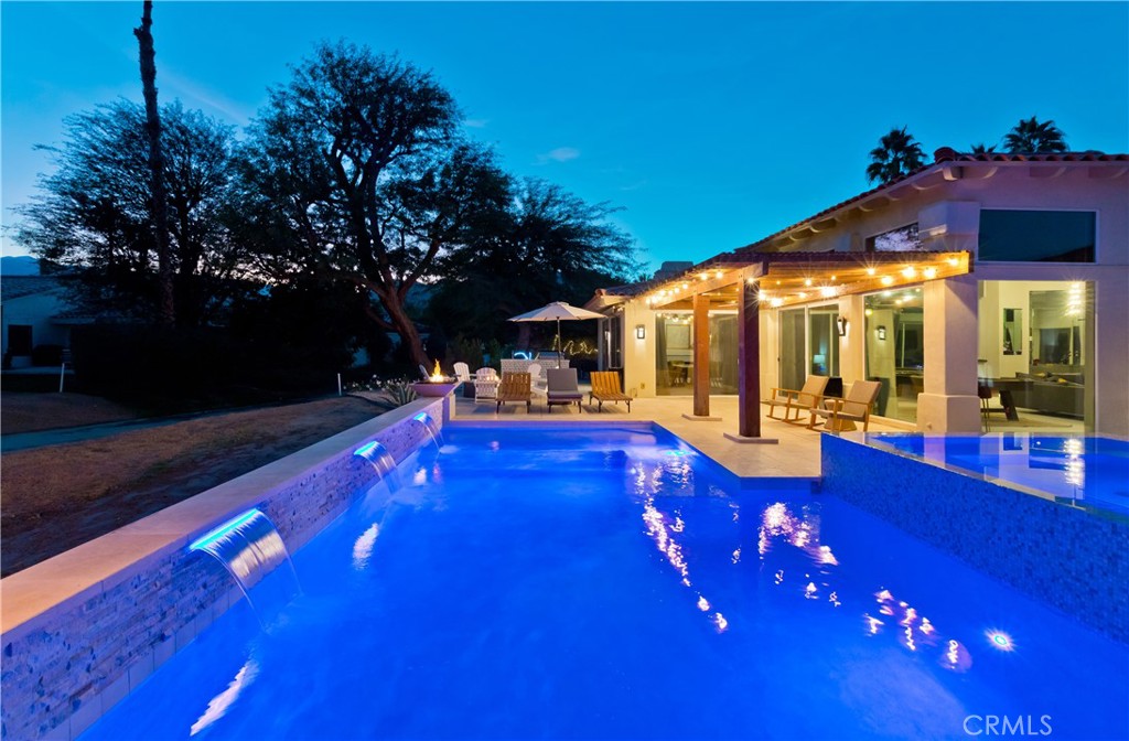 a view of an house with swimming pool patio and garden