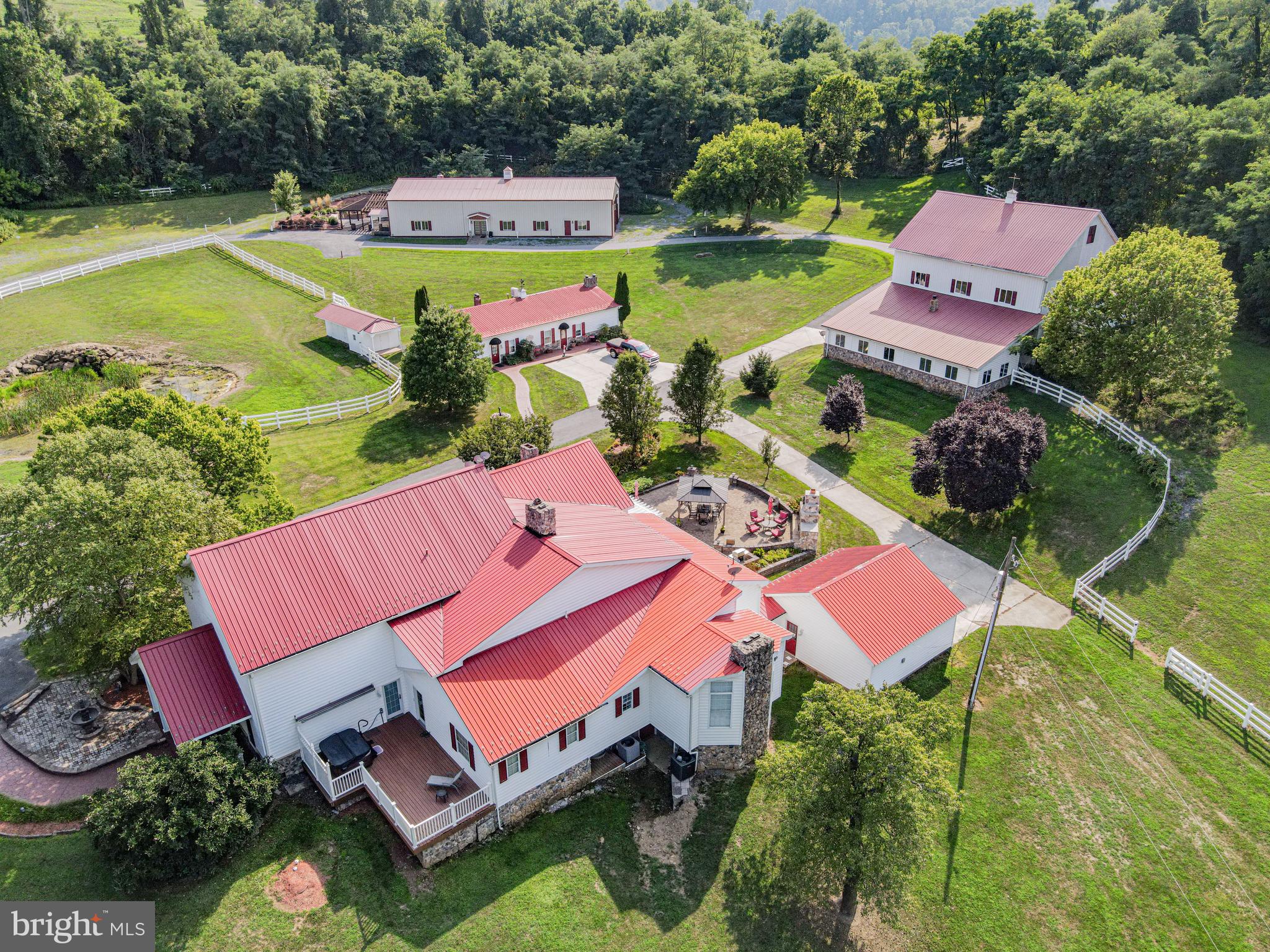 an aerial view of a house with swimming pool a yard and outdoor seating