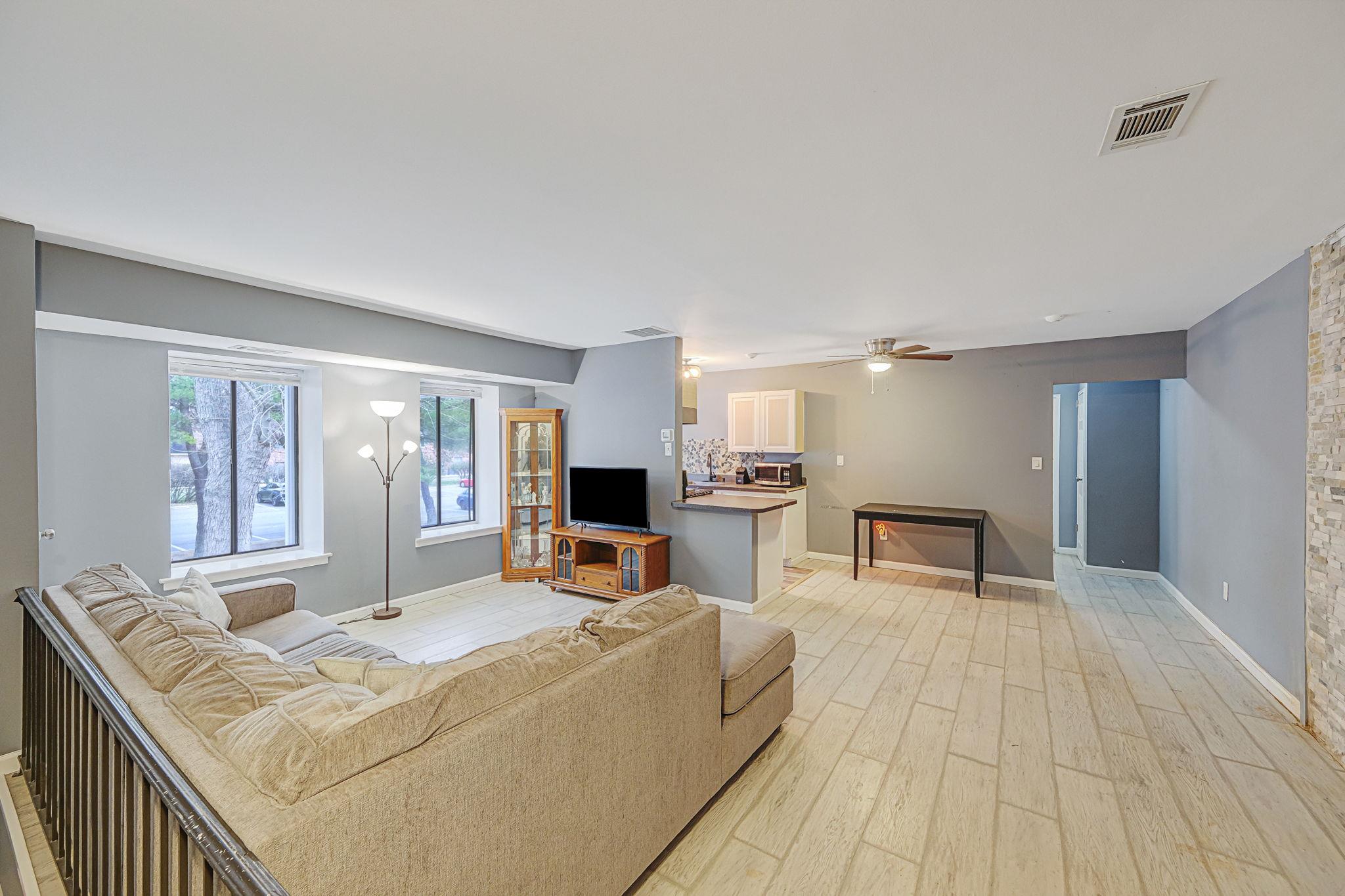 Living room featuring ceiling fan and light wood-type flooring