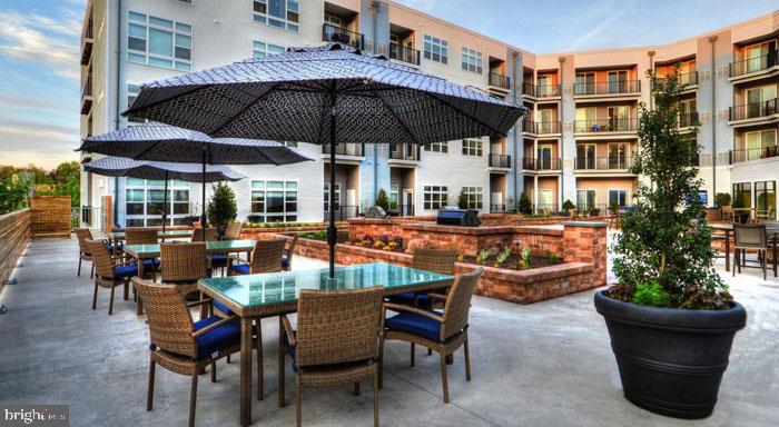 a view of a patio with table and chairs under an umbrella