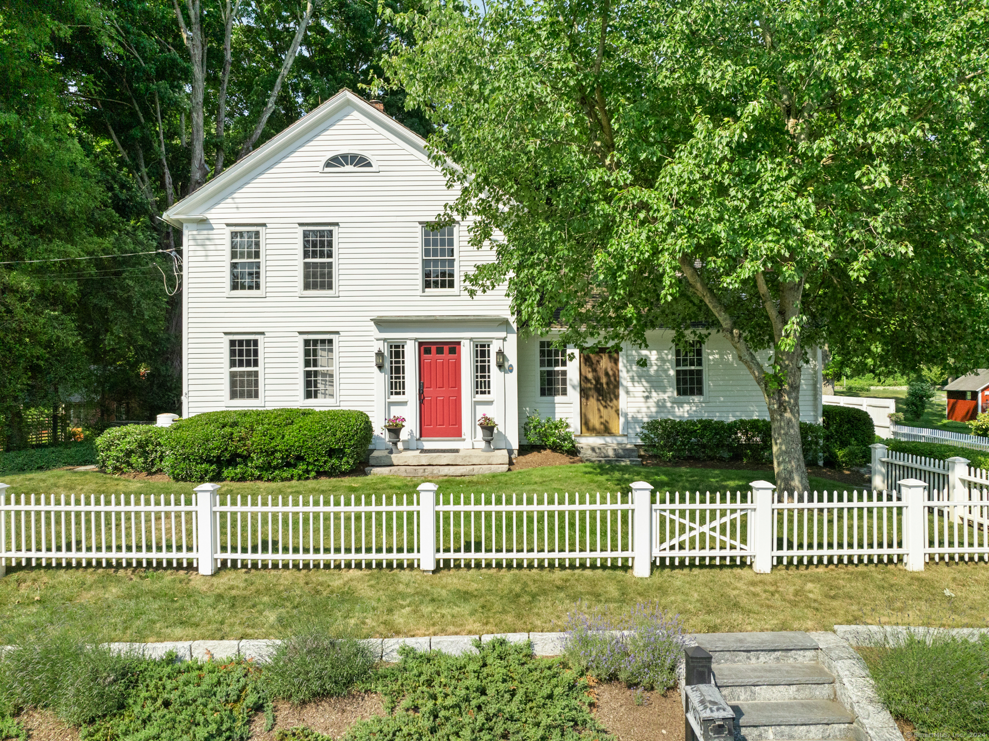 a front view of a house with a garden and deck