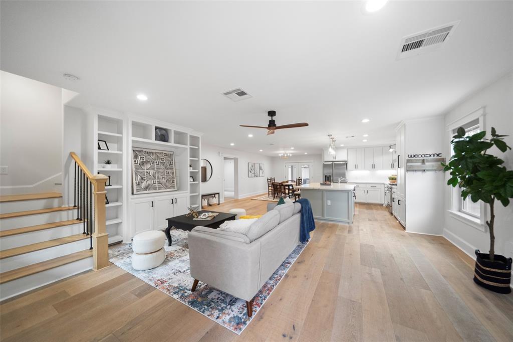 Upon entry you will be greeted by a spacious, modern, open-plan living room with an adjoining kitchen and dining, featuring hardwood floors, recessed lighting and designer finishes.