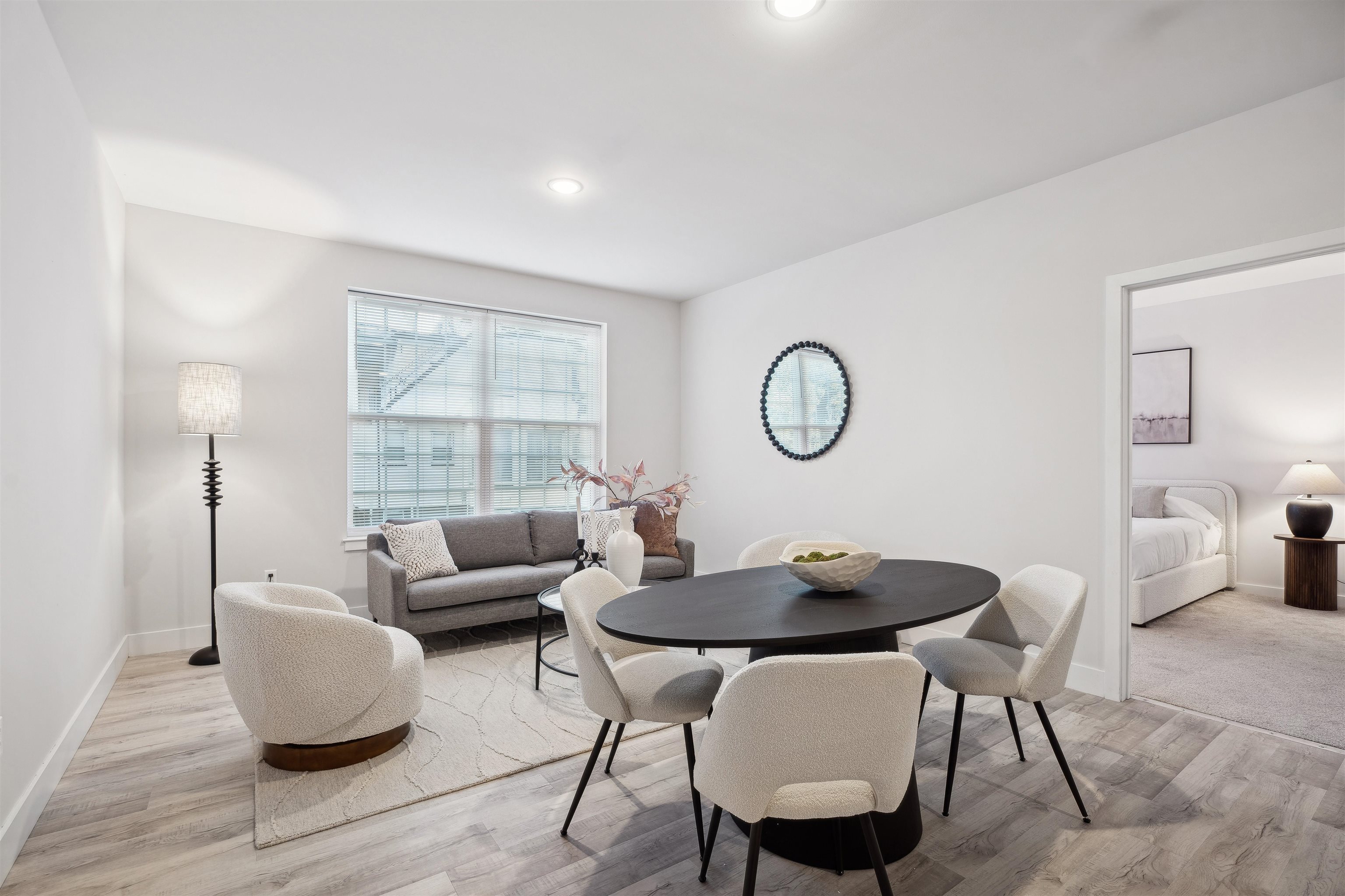 a living room with furniture a window and a table