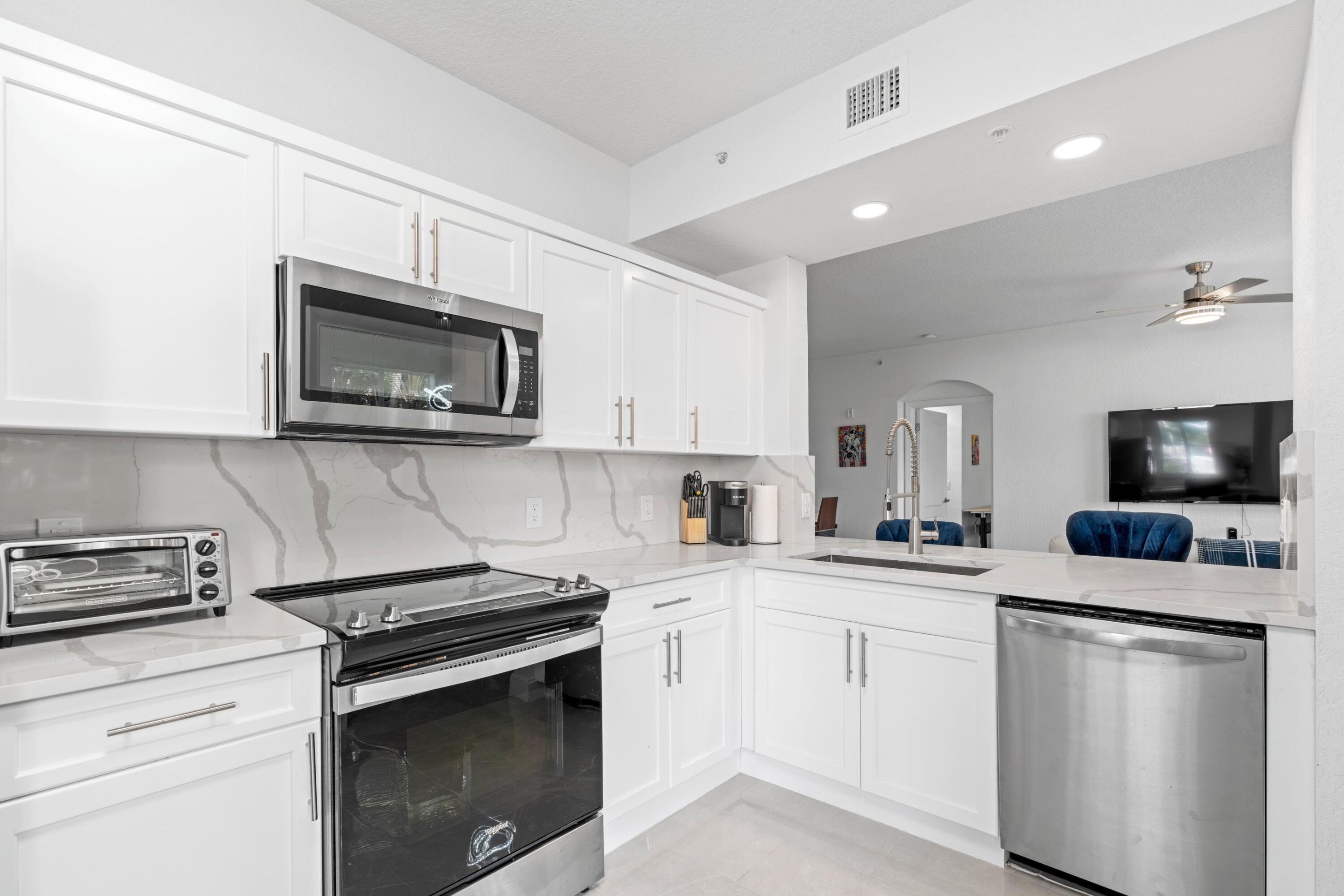 a kitchen with a sink stove and microwave