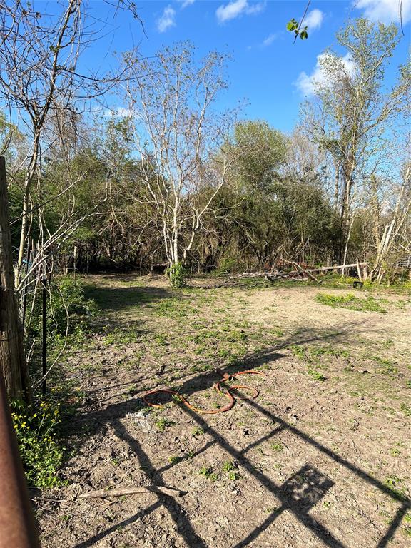 a view of a yard with wooden fence