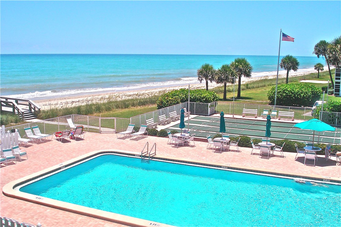 a view of a swimming pool and lounge chairs