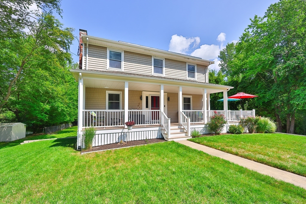 a front view of house with yard and green space