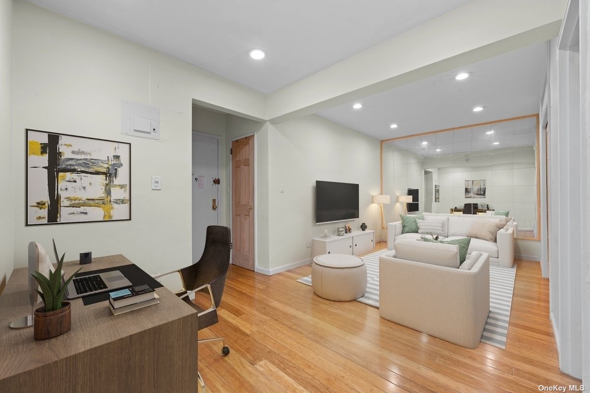 a living room with furniture a flat screen tv and a large window