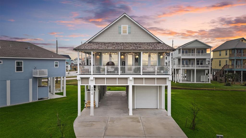 Bask in the beauty of this elevated 3-year-old custom-crafted home, showcasing stunning architectural details and a spacious covered balcony that captures the charm of Laguna San Luis on Galveston's West End.