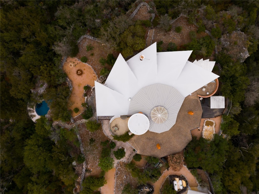 an aerial view of a house with a swimming pool and outdoor seating