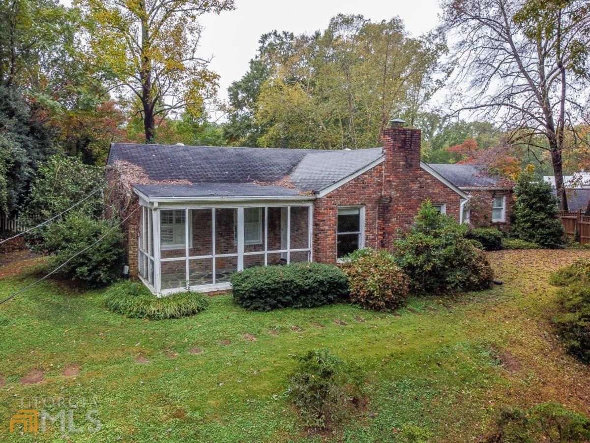 a view of house with yard and green space